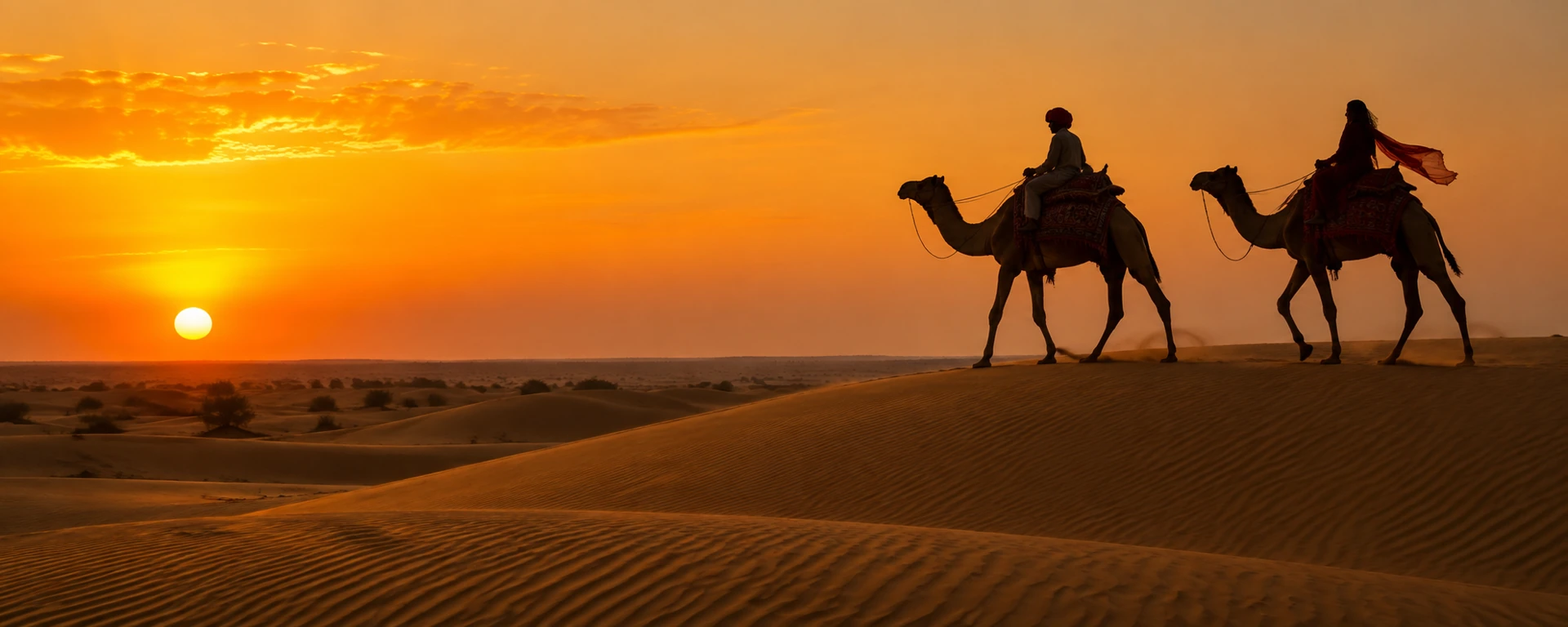 Camel safari in Jaisalmer sand dunes at sunset